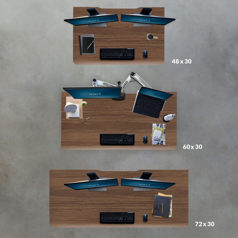 Overhead comparison of three walnut desktop sizes: forty-eight by thirty inches with dual monitors, sixty by thirty inches with a monitor and laptop arm, and seventy-two by thirty inches with dual monitors. image number null